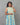 A women wearing collored printed a-line cotton kurti on a grey background