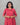 Woman wearing a red feeding kurti with butta against a gray background