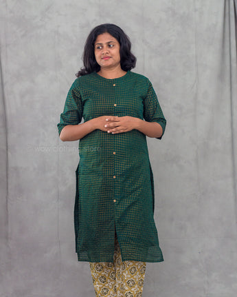 Women wearing a green checkered kurti in a gray background