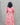 Person wearing a pink floral dress against a gray background