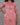 Woman wearing a pink floral kurti against a gray background