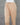 Beige pants on a mannequin against a gray background