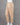 Beige cotton pants worn by a person on a gray background