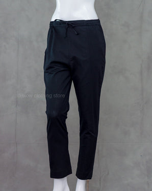 Black pants on a mannequin against a gray background