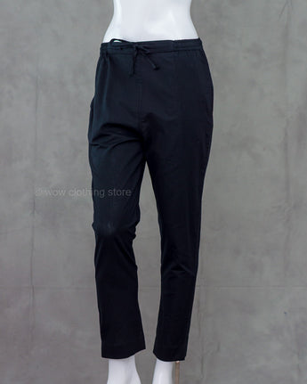 Black pants on a mannequin against a gray background