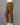 Brown pants on a mannequin against a gray background