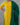 Person wearing a yellow kurta with green dupatta against a gray background