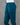 Dark teal pant on a mannequin against a gray background