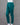 Teal green pants on a mannequin against a gray background