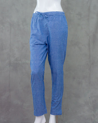Denim blue cotton bottom on a mannequin against a gray background
