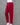 Red cotton pants on a mannequin against a gray background