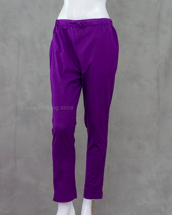 Purple cotton pants on a mannequin against a gray background