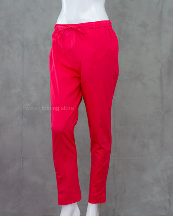 Red pink cotton pants on a mannequin against a gray background