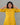 A women wearing a plain yellow kurti with mirror work and plain bottom