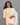 Woman wearing a yellow kurti with white printed dupatta against a gray background