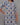 Woman wearing a patterned kurti against a gray background