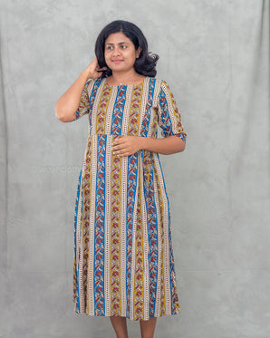 Woman wearing a printed feeding kurti against a plain background