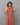 A women wearing a kalamkari printed pure cotton collored kurti on a grey background