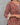 Woman wearing a kalamkari patterned dress against a gray background