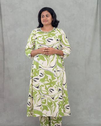 Woman wearing a green and white patterned kurti set against a gray background