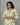Woman wearing a green and white patterned dress against a gray background
