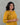Woman wearing a mustard yellow modal kurta set with floral embroidery against a gray background