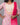 Woman wearing a pink and white embroidered outfit with a pink dupatta against a gray background