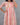Woman wearing a patterned dress against a gray background