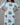 Woman wearing a sky blue dress with a floral pattern on a gray background