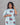 Woman wearing a patterned dress with a gray background