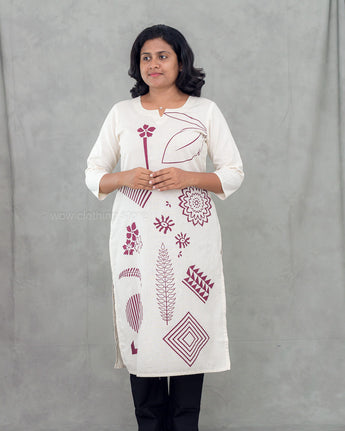 A women wearing a printed beige color cotton kurti on a grey background