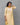 A women wearing yellow color printed modal kurti suit with plain bottom and a dual color dupatta on a grey background