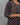 A lady wearing a printed black cotton kurti on a grey background
