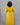 Person wearing a yellow dress with a gray background