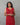 A women wearing tie and dye red color cotton kurti on a grey background