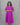 Woman wearing a purple maternity dress with zigzag patterns against a gray background