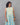 A women wearing collored printed a-line cotton kurti on a grey background