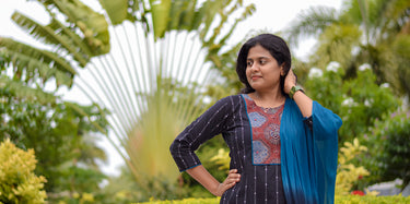Women wearing a black kurti with dupatta against a nature background