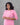 Woman wearing a pink traditional outfit with a gray background