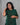Women wearing a green checkered kurti in a gray background 