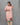 Woman wearing a pink kurti with a gray background