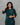 Woman wearing a green with floral patterns modal kurti set against a gray background
