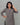 Gray dress with black palm tree patterns on a plain background