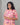 Woman wearing a pink floral dress against a gray background