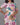 Woman wearing a floral dress with a grey background