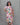 Woman wearing a floral kurti with a plain background