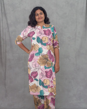 Woman wearing a floral kurti with a plain background