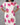 White dress with pink floral patterns worn by a person on a gray background