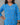 Person wearing a blue patterned dress with a gray background