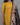 Women wearing a yellow kurti with a kalamkari dupatta against a gray background